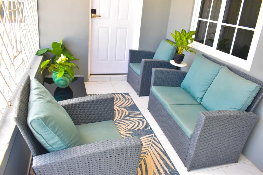 Back veranda seating with teal cushions beside the kitchen door